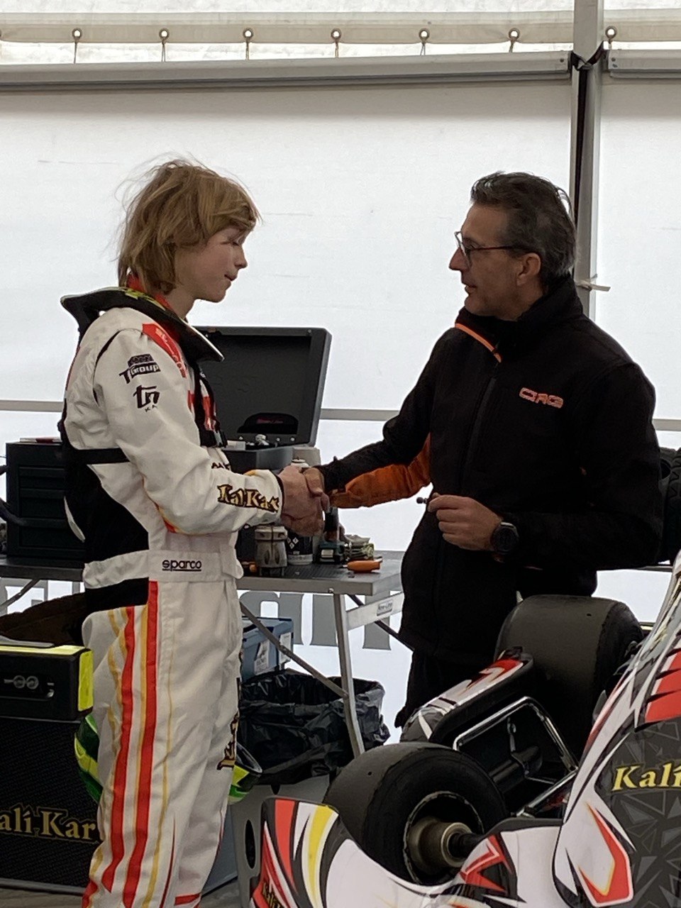 Trofim Krotov in the paddock with team management.