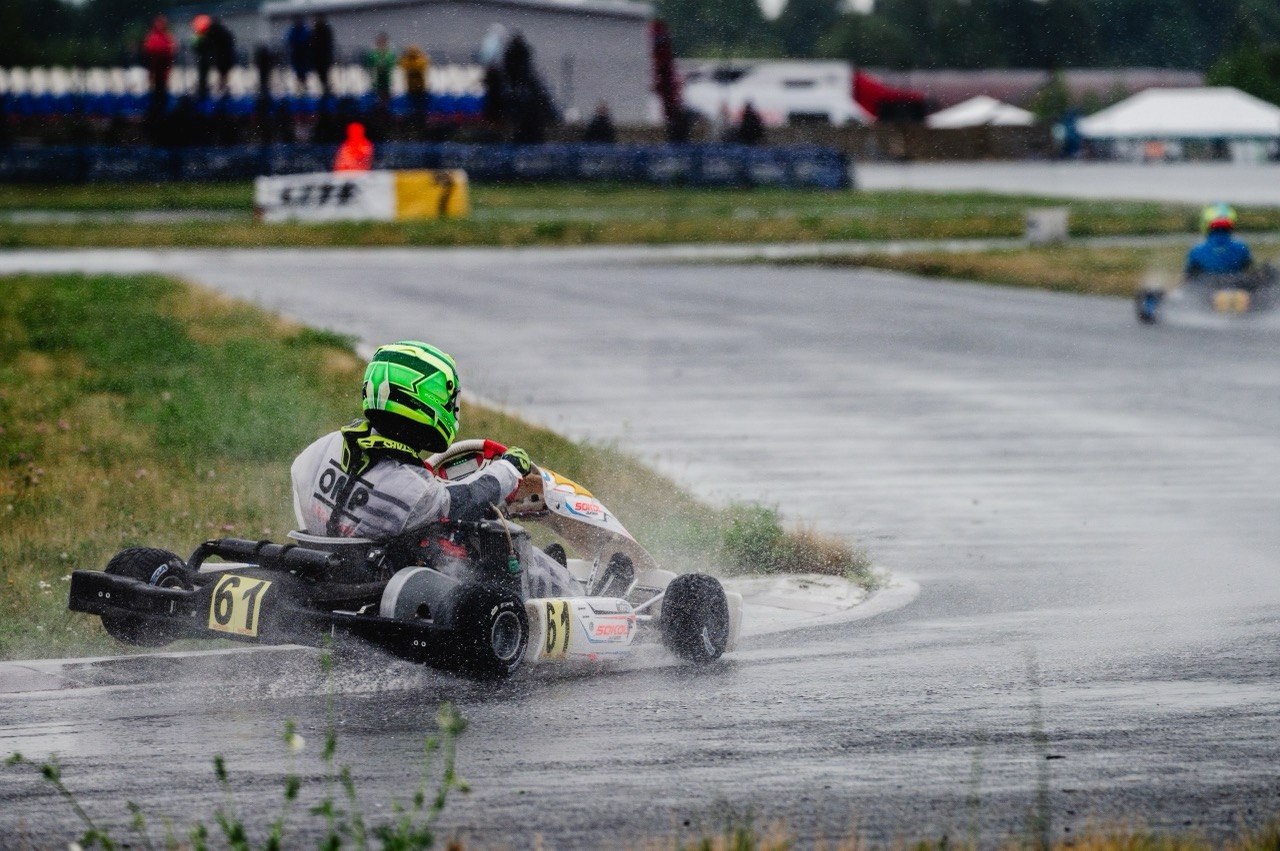 Trofim Krotov racing wheel-to-wheel in wet conditions.